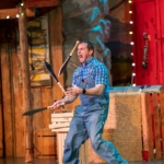 A man juggles knives at the Comedy Barn.