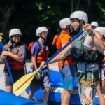 A group of people being instructed before going on their rafting trip.