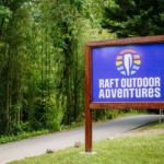 The sign for Raft Outdoor Adventures in Hartford, TN.