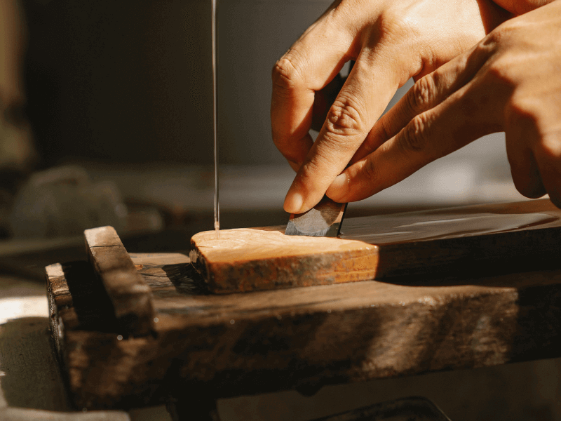 Artisan sharpening chisel in workshop