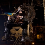 Blackbeard sits on a throne with a blue and yellow parrot at the Pirates Voyage Dinner & Show in Pigeon Forge.