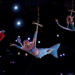 Three mermaids perform aerial acrobatics on anchors in Pigeon Forge, TN. Located at Pirates Voyage Dinner & Show.