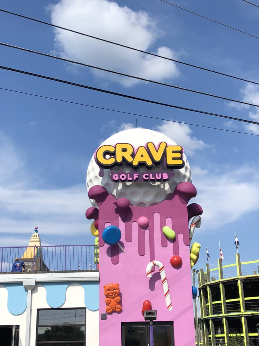 Family playing mini golf at Crave Golf Club - Pigeon Forge