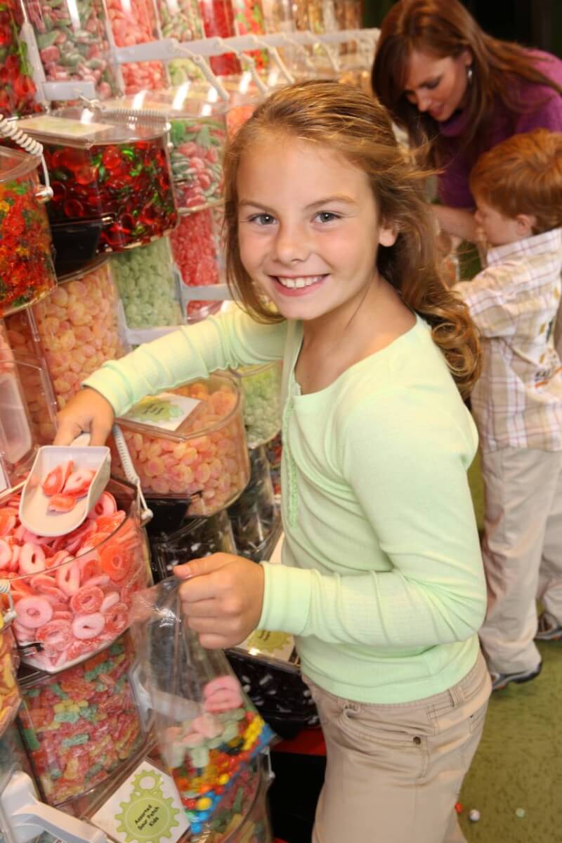 Child scooping candy at Ripley's Candy Factory