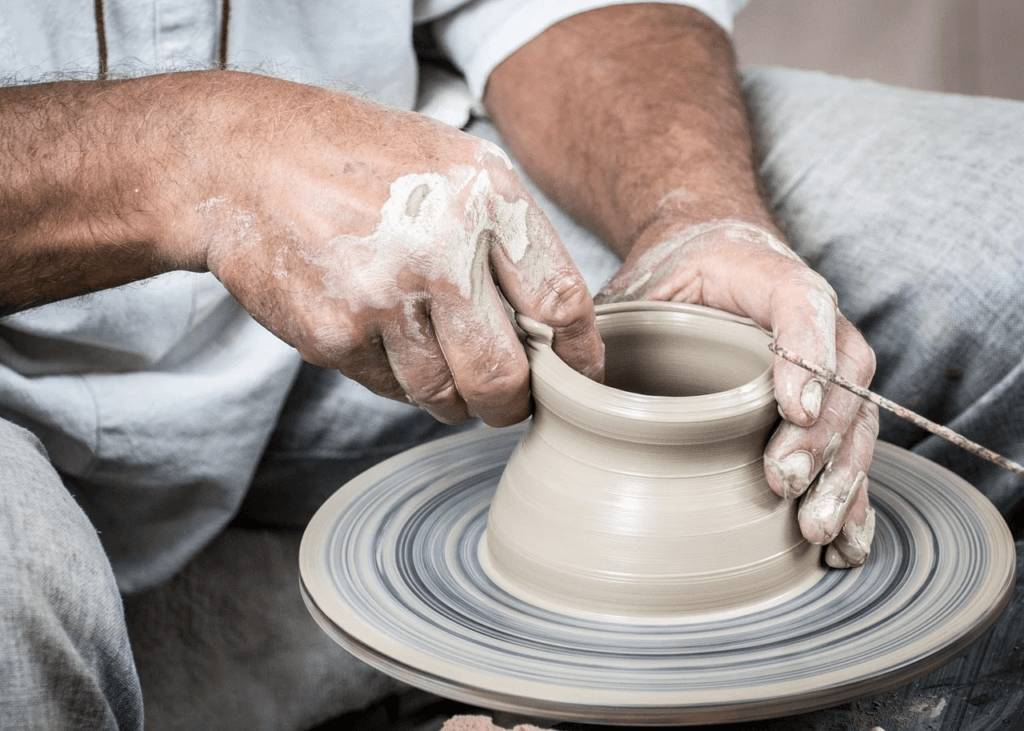 an artisan spins a clay pot at the Great Smoky Arts & Crafts Community